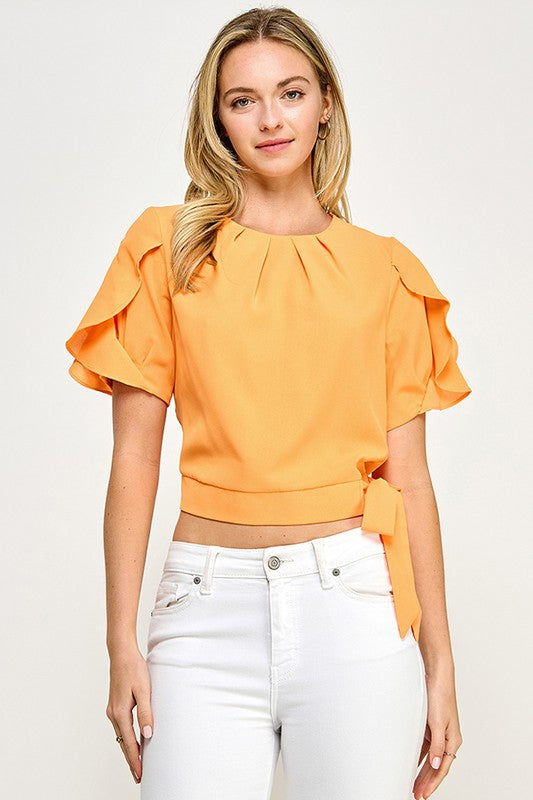 Blusa naranja con mangas de volante y cintura ajustable