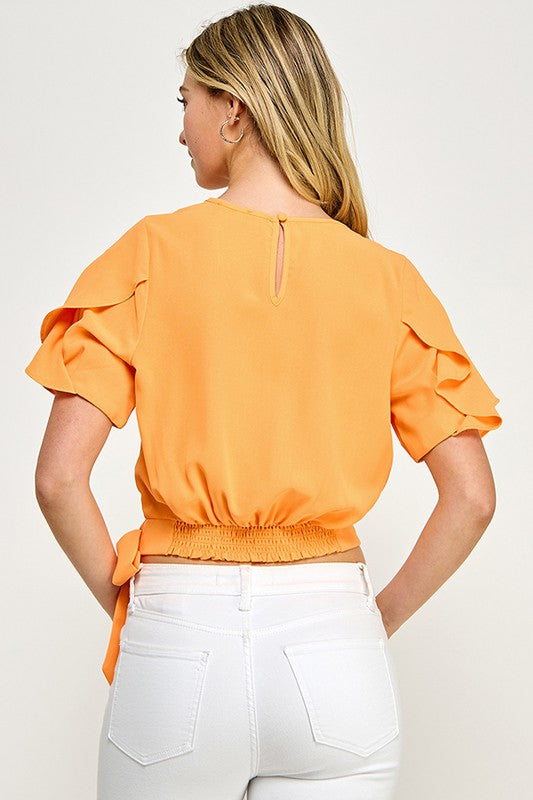 Blusa naranja con mangas de volante y cintura ajustable